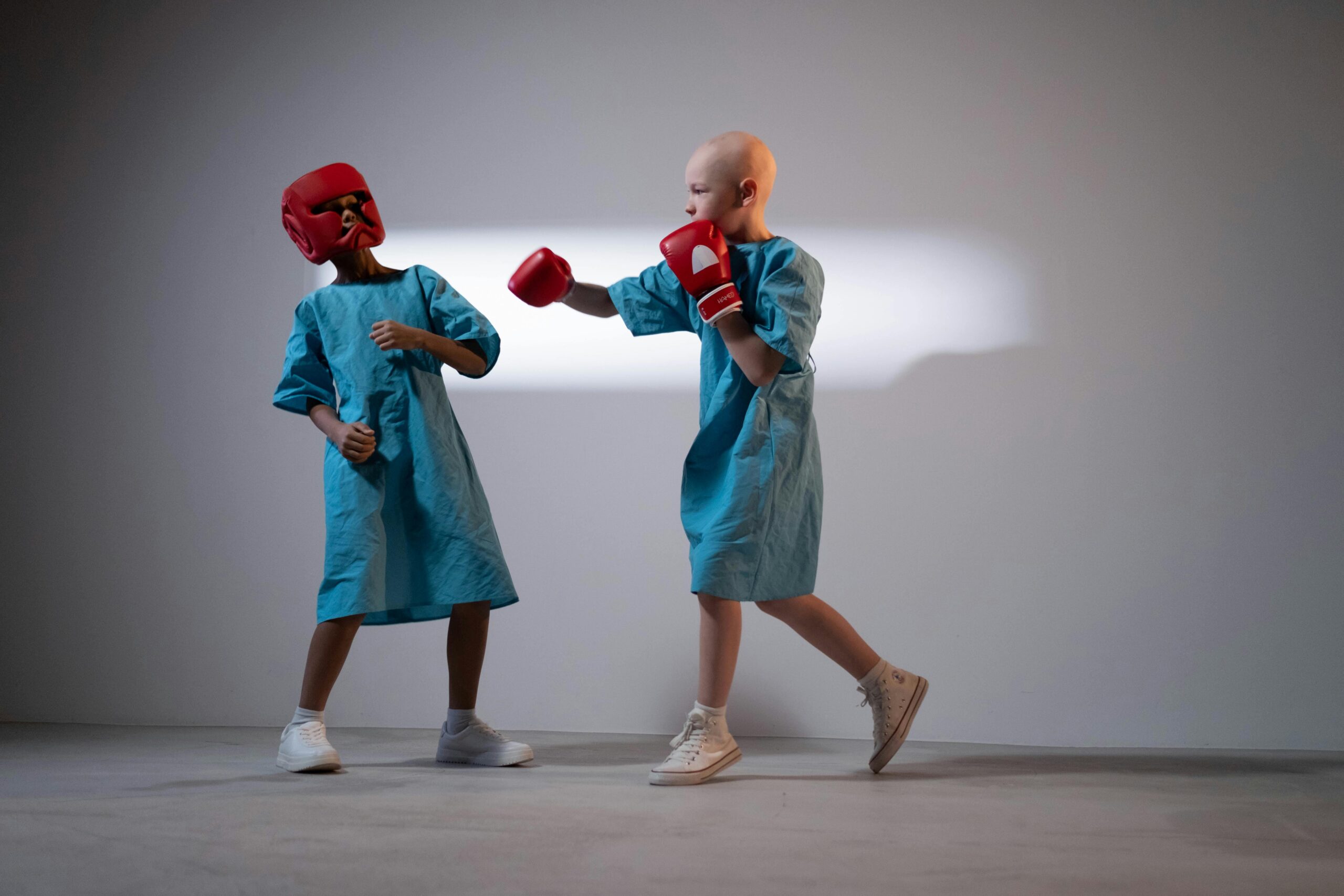 Young cancer patients sparring in a studio, symbolizing strength and resilience.